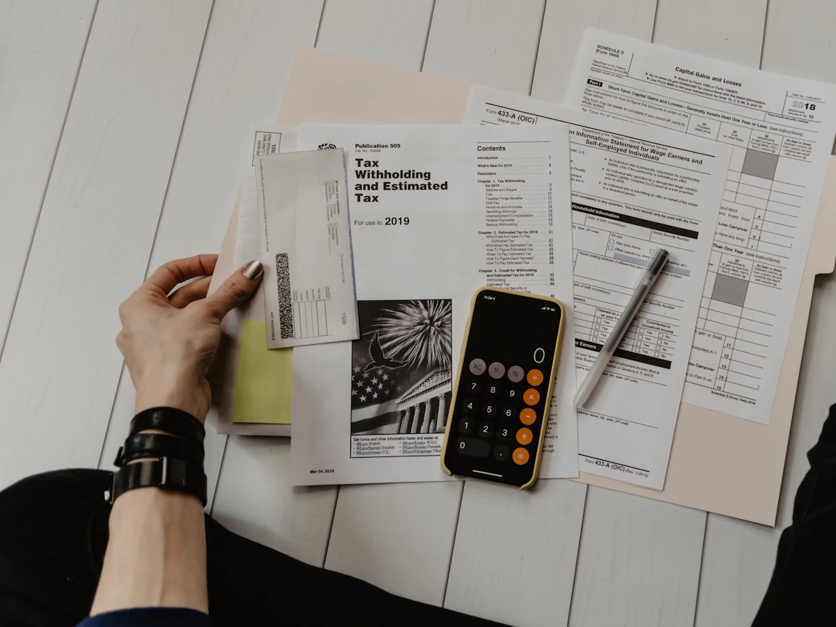 Printed terms documents with a pen and calculator on a desk
